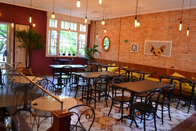 salão de um café com mesas e cadeiras