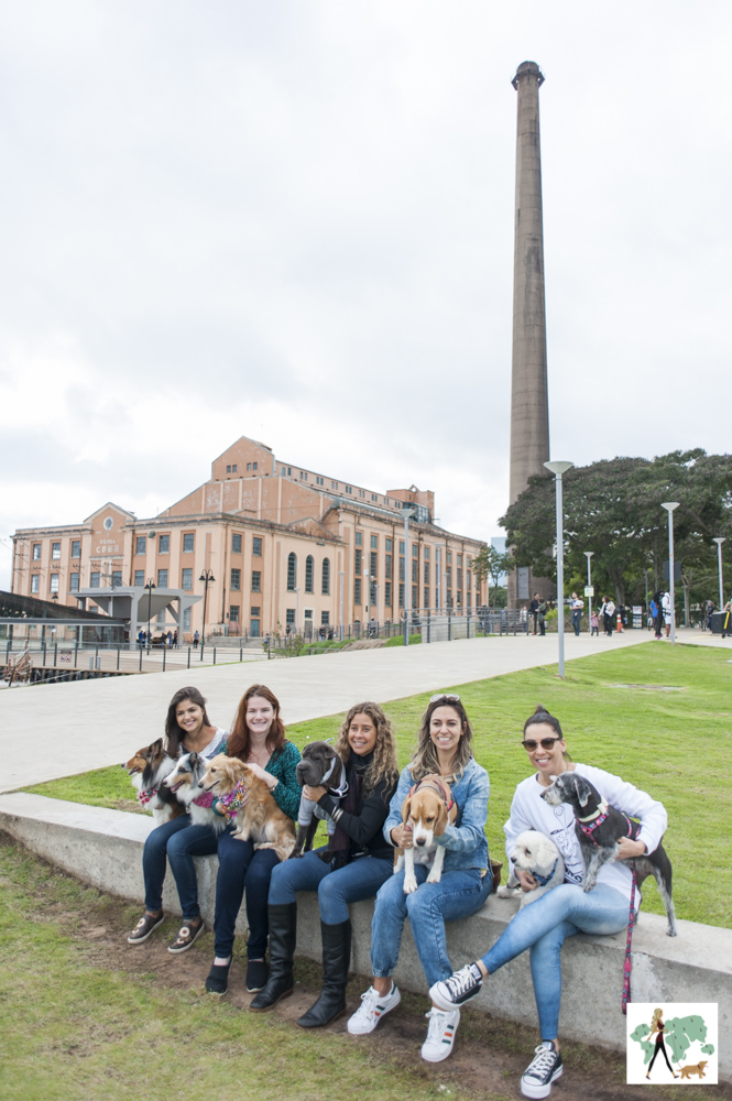 mulheres e cachorros no colo na orla do Guaíba com o gasômetro ao fundo